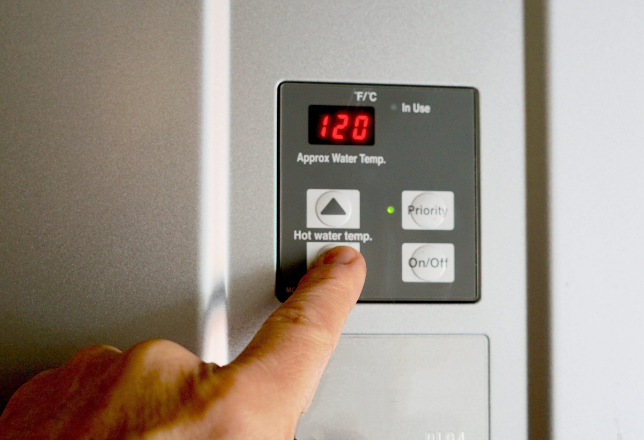finger-on-hot-water-heater-control-unit-FKNWETA